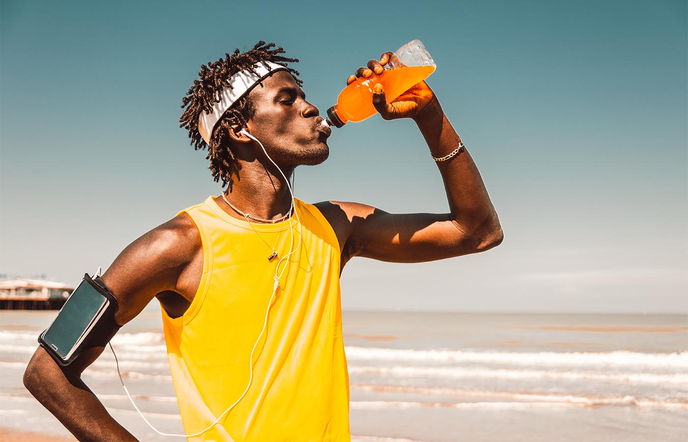 A male athlete drinking an electrolyte sports drink